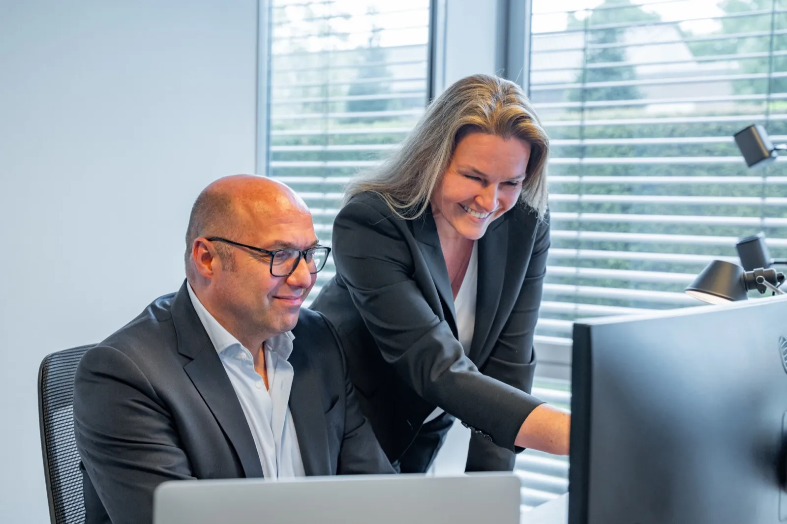 Christian Krämer und Ute Wedekind arbeiten gemeinsam am Bildschirm